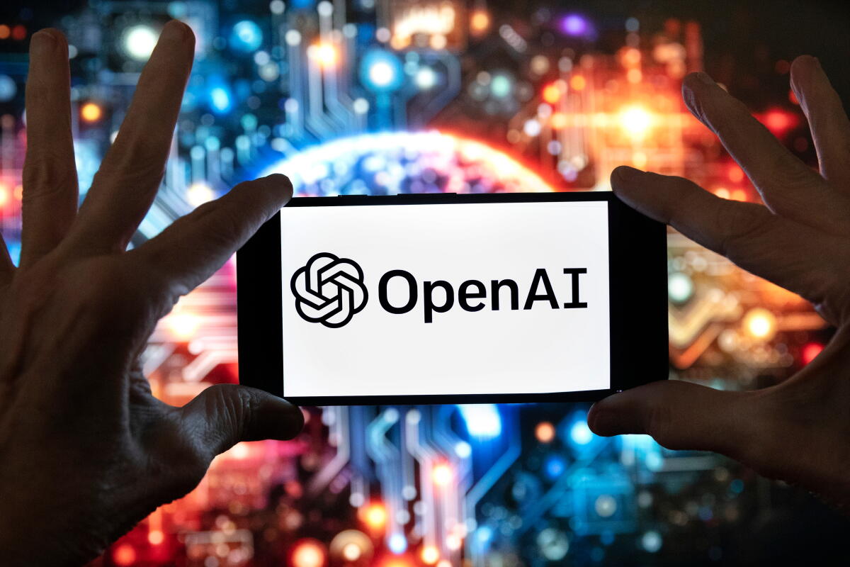 OpenAI logo displayed on a smartphone against a colorful technology background
