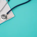 Stethoscope beside a medical appointment notebook