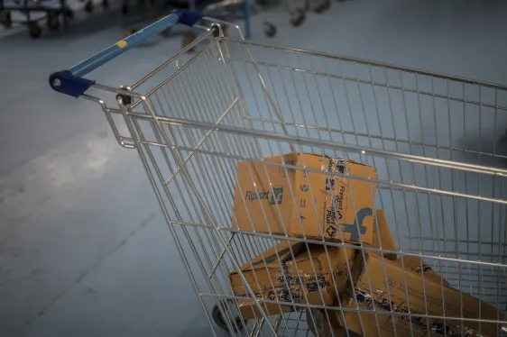 Shopping cart with packages representing online commerce