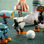 Small Microduck robots playing with a ball