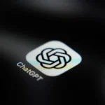OpenAI logo on a phone screen; illustrative image